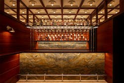 Gridded and recessed ceiling detail is demurely illuminated by diffused downlighting. Gridded and recessed ceiling detail is demurely illuminated by diffused downlighting.