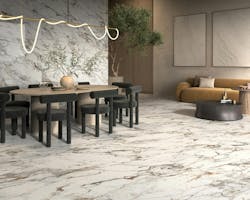 The “Veins of Gold” of Indulge by Panariagroup USA glimmer in a sumptuous dining and lounge area. The “Veins of Gold” of Indulge by Panariagroup USA glimmer in a sumptuous dining and lounge area.