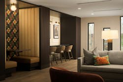 Sophisticated patterns on accent walls with booth seating, countertop, and plush armchairs and sofas mainly in gray and camel tones. Sophisticated patterns on accent walls with booth seating, countertop, and plush armchairs and sofas mainly in gray and camel tones.