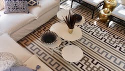 Tanzania Key Rug from the Meredith Heron Collection surrounded by couches and tables. Tanzania Key Rug from the Meredith Heron Collection surrounded by couches and tables.