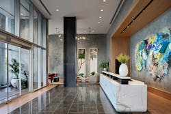 Visitors are immediately welcomed into the cool and understated reception area with its layered stone and wood finishes that provide shelter from the Texas heat, and are accented with a pop of color from locally sourced artwork. Visitors are immediately welcomed into the cool and understated reception area with its layered stone and wood finishes that provide shelter from the Texas heat, and are accented with a pop of color from locally sourced artwork.