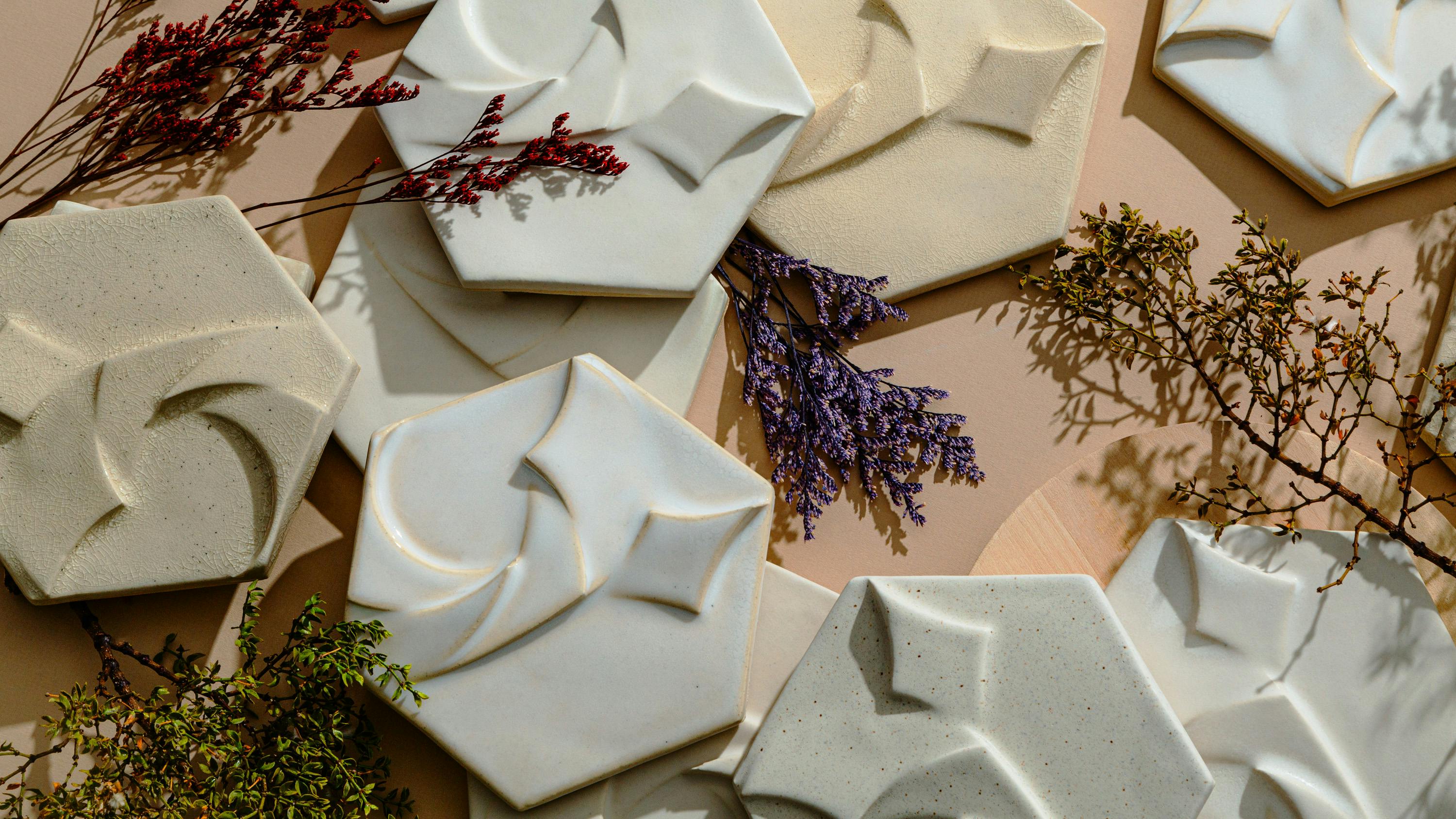 Assortment of textured fractal-inspired tiles surrounded by flowers.