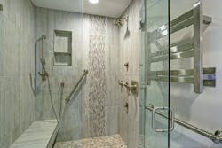 Walk-in/roll-in shower in bathroom with grab bars and removable shower head Walk-in/roll-in shower in bathroom with grab bars and removable shower head