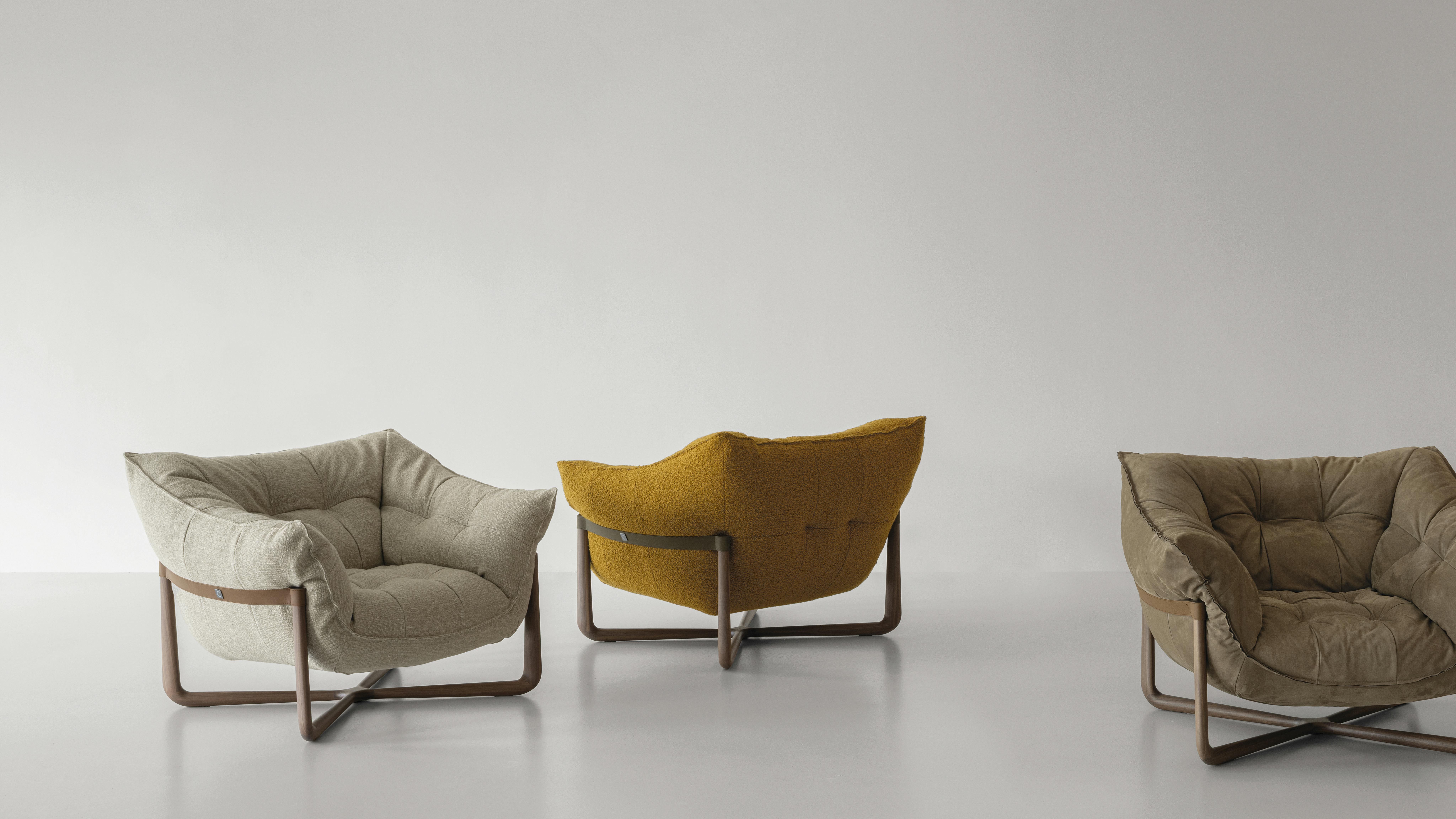 Three Donald armchairs set in a studio.
