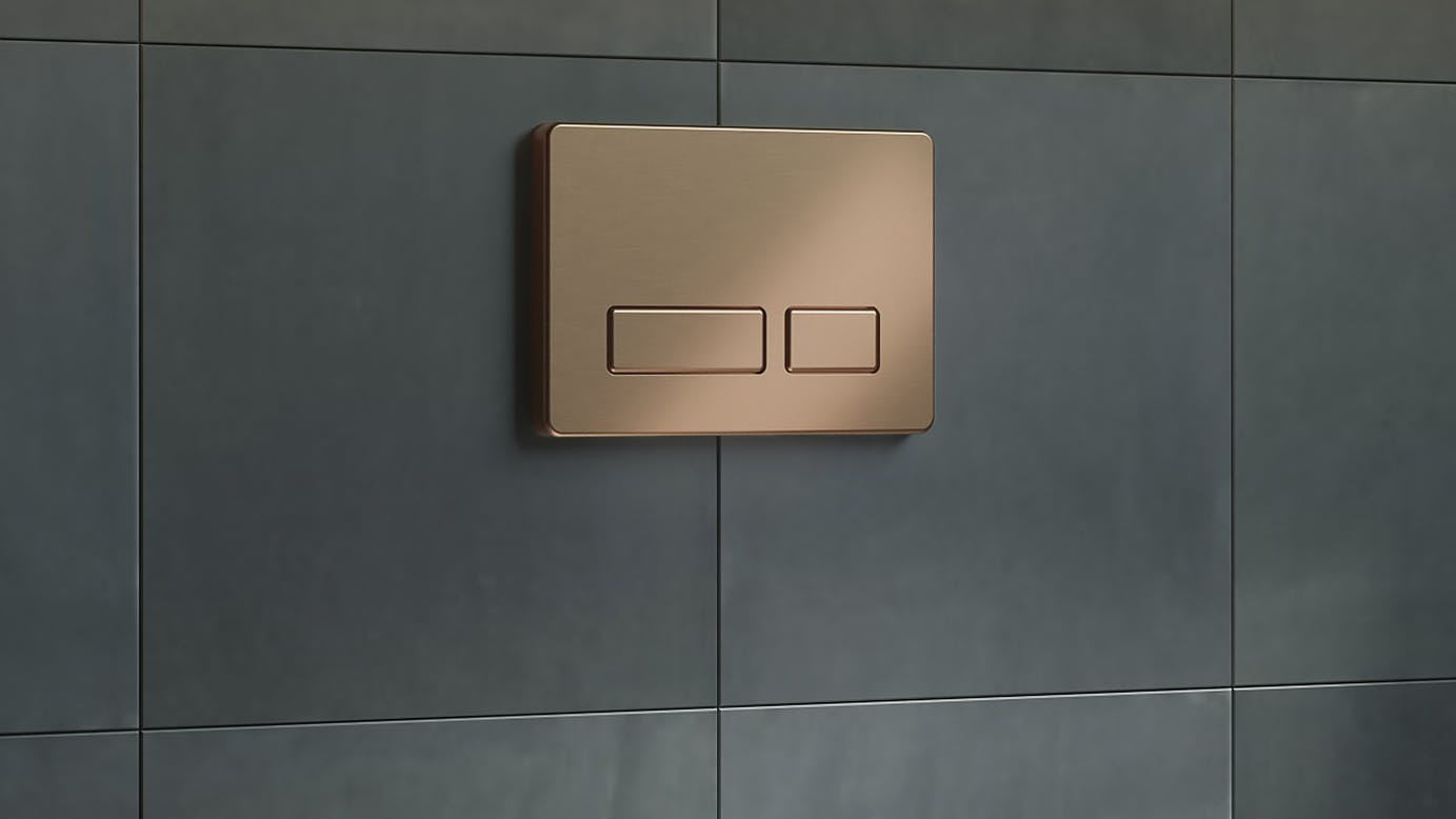 California Faucets Dual-Flush Actuator Flush Plate in Satin Bronze (PVD) finish, installed above a toilet.