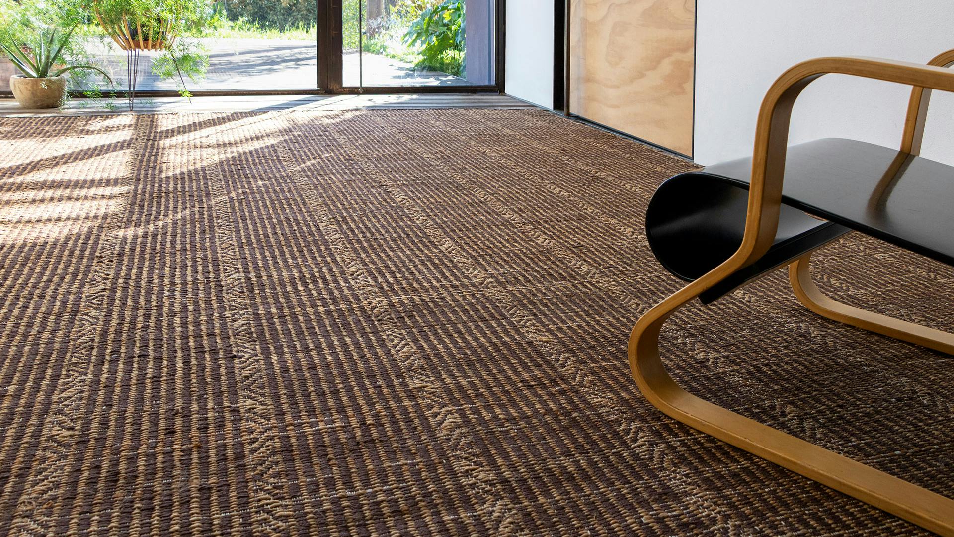 G.T.Design's Sahil modern jute rug in Terra color laid on a living room floor.
