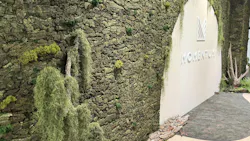 The Momentum showroom at NeoCon 2025 features an expansive green wall.