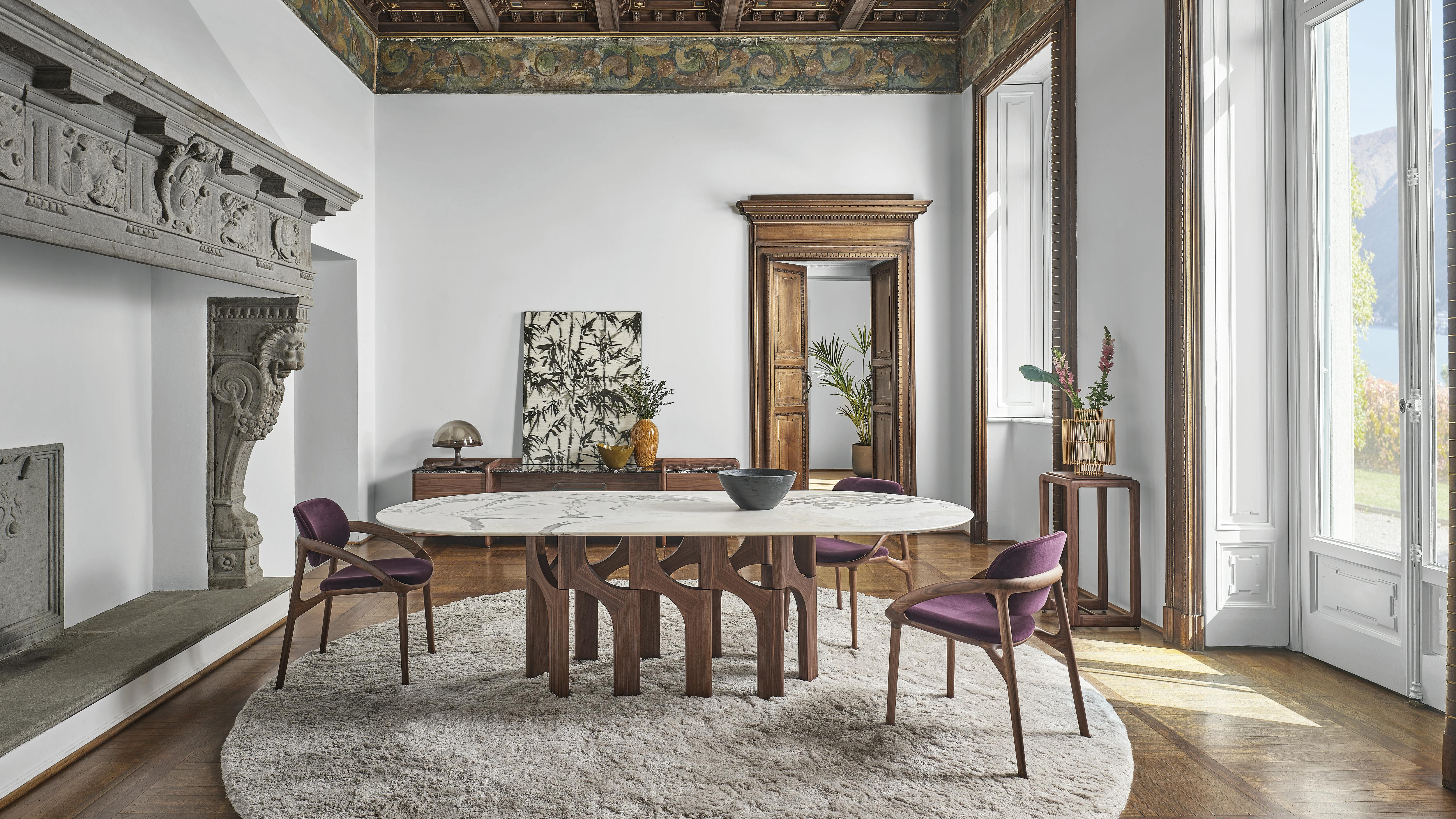 The Augusto table, shown in an oval shape, comes in various size options.