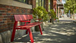 The Glide Bench, shown in red, creates a place to rest along a sidewalk. The Glide Bench, shown in red, creates a place to rest along a sidewalk.