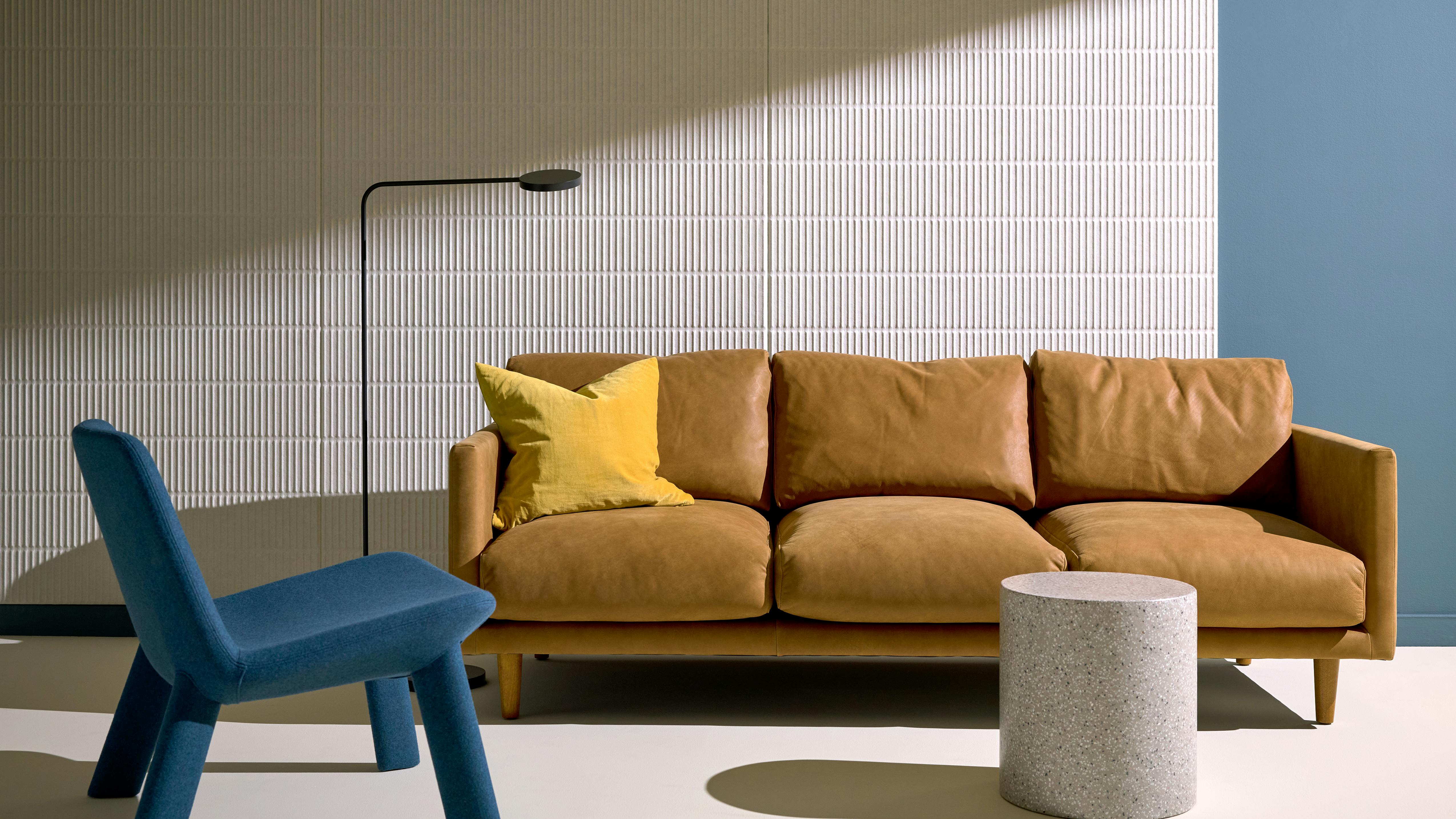 3form's Ozner Profile Panel in Milky White Merino Felt installed behind a couch.