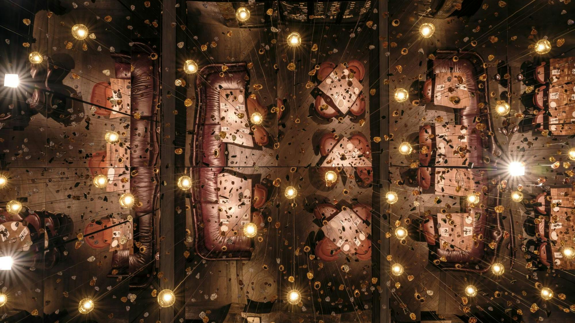 View looking toward the ceiling: The chandelier installation symbolizes how food and iron are forged in flame.