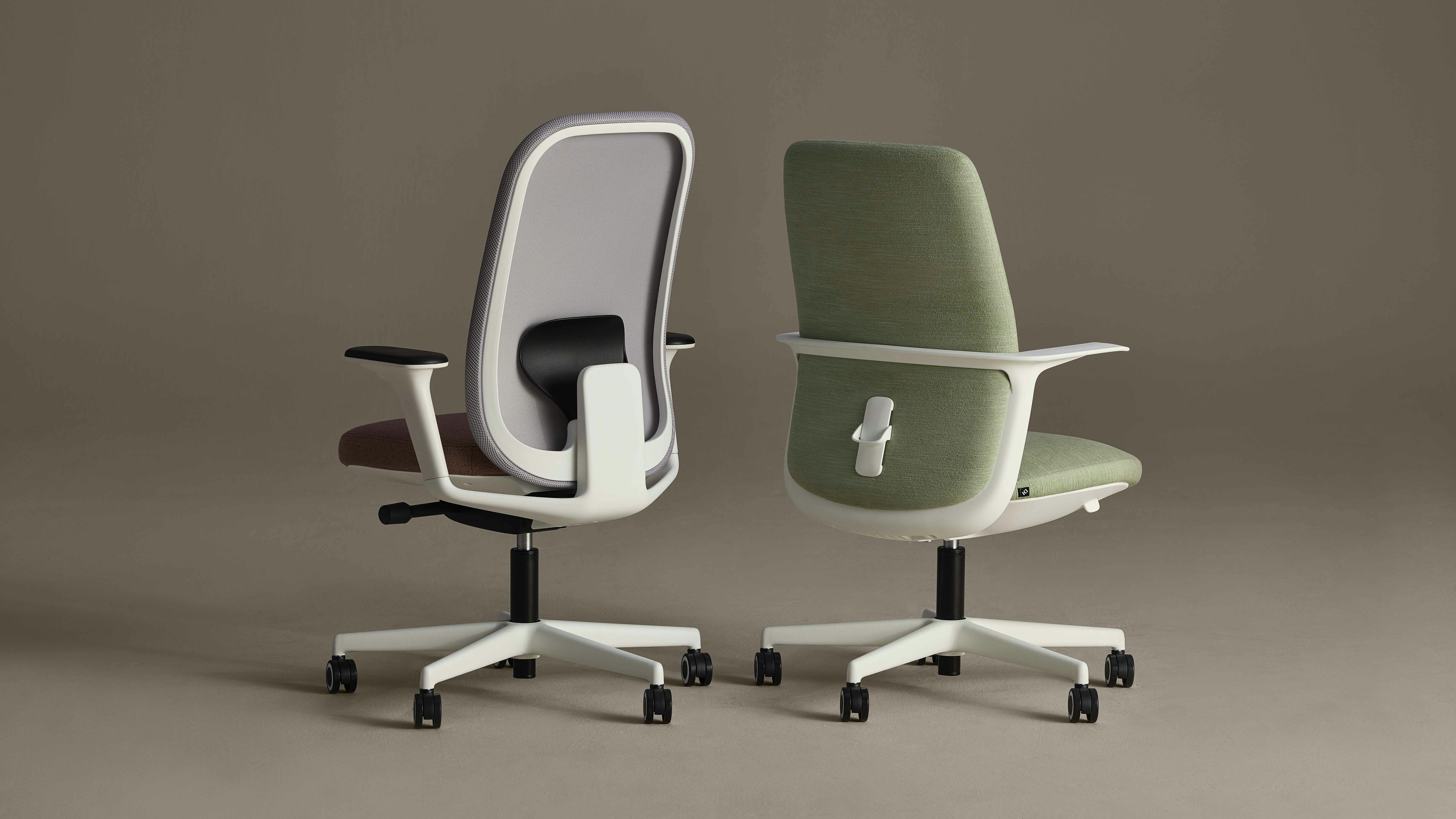 Backside view of two task and conference chairs with white frames and upholstered seat and back on casters.