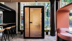Privacy pod with frosted glass door in modern office interior space. Privacy pod with frosted glass door in modern office interior space.