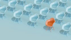Rows of identical light blue chairs with one orange chair in first row that stands out. Rows of identical light blue chairs with one orange chair in first row that stands out.
