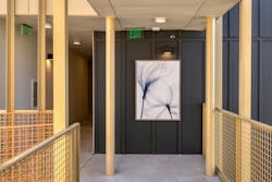 Abstract artwork of flowers seen at end of hallway with gold railings on either side. Abstract artwork of flowers seen at end of hallway with gold railings on either side.
