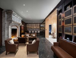 Inspir Embassy Row DC library features classic brown leather furniture, dark wood paneled walls, and a vintage marble fireplace for cozy ambiance Inspir Embassy Row DC library features classic brown leather furniture, dark wood paneled walls, and a vintage marble fireplace for cozy ambiance