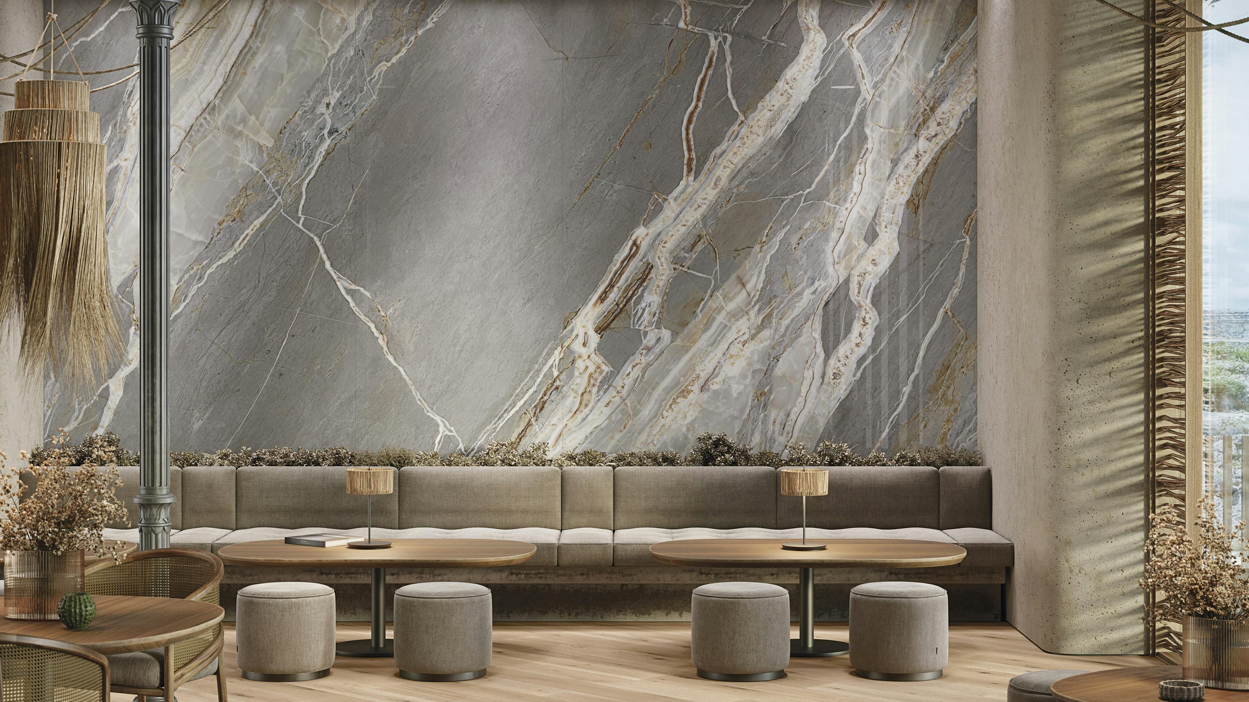 Large format wall tile that mimics dark marble in a lounge environment with booths and tables.