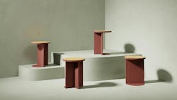 Four small, circular side tables with wood tops on display on pedestals of differing heights. Four small, circular side tables with wood tops on display on pedestals of differing heights.
