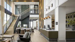 High-end hotel lobby with grand staircase, lounge furniture, and reception desk with warm tones and gold details.