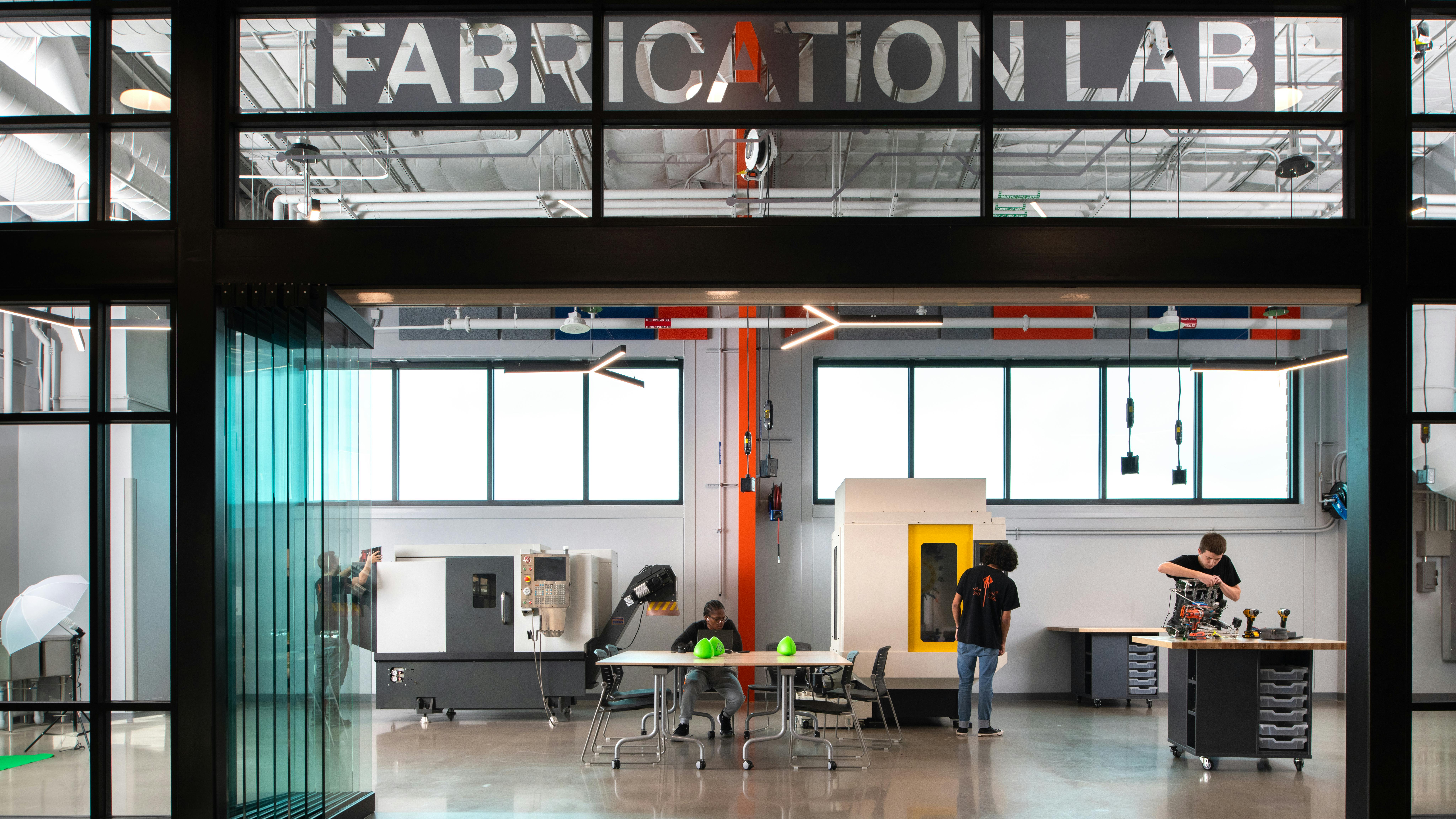 The fabrication lab features 3D printers, tools, equipment, and stations for working on projects.