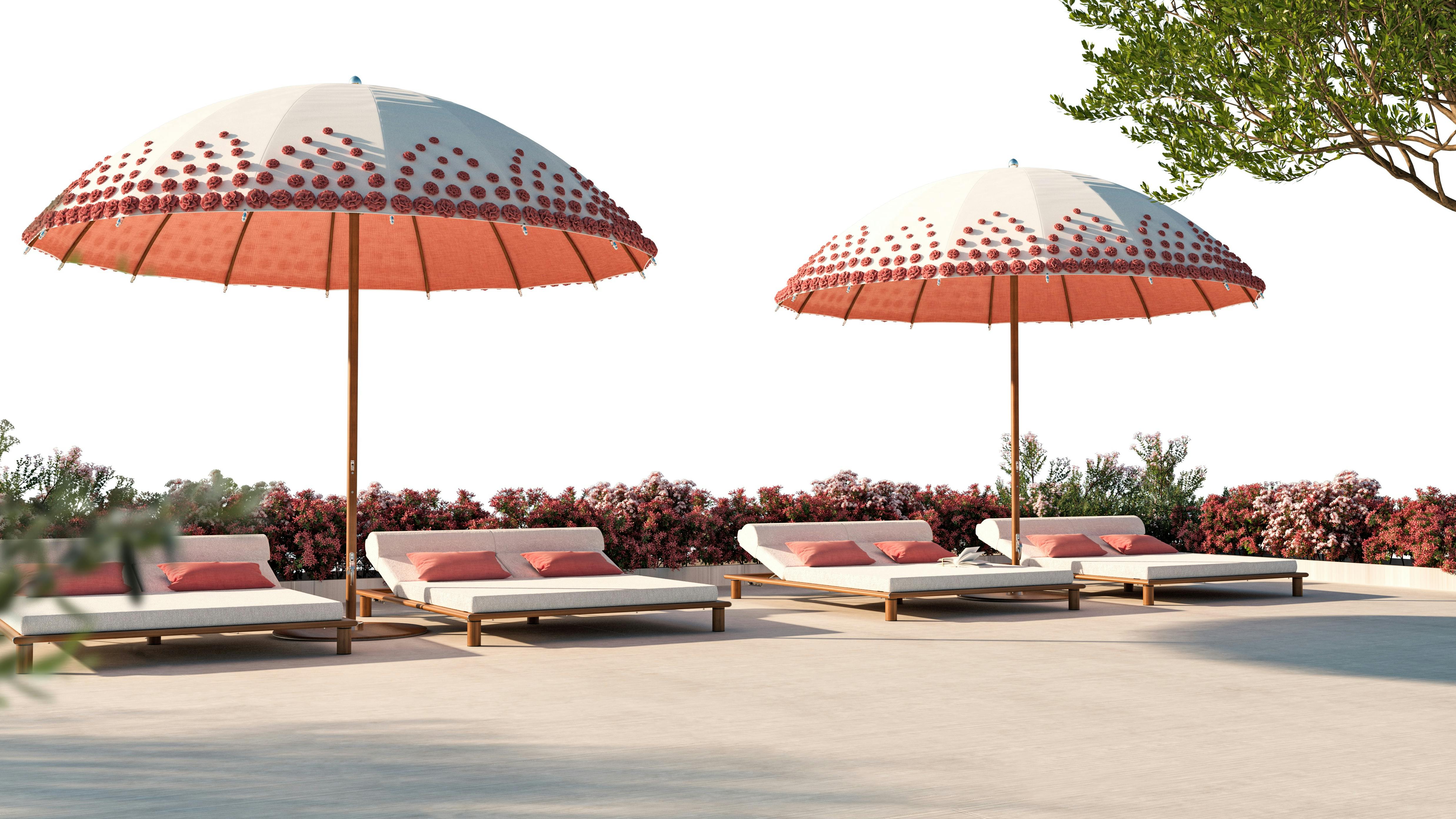 Tuuci&rsquo;s Ocean Master MAX Bolero: Ombr&eacute; Blossom parasol set alongside outdoor lounge chairs.