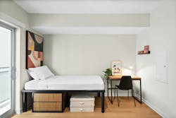 Berkeley Building bedroom single unit furnished with compact desk and chair, and a high platform bed for under-bed storage. Berkeley Building bedroom single unit furnished with compact desk and chair, and a high platform bed for under-bed storage.