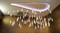 A round LED chandelier illuminates the ceiling and surround walls. A round LED chandelier illuminates the ceiling and surround walls.