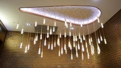 A round LED chandelier illuminates the ceiling and surround walls. A round LED chandelier illuminates the ceiling and surround walls.