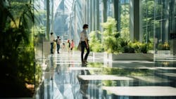 Commercial building entry with large windows, abundant daylight, and greenery Commercial building entry with large windows, abundant daylight, and greenery