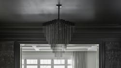 Kelly Chandelier X-Large in black from Gabriel Scott suspended over a table. Kelly Chandelier X-Large in black from Gabriel Scott suspended over a table.