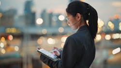 Businesswoman using tablet with artificial intelligence application Businesswoman using tablet with artificial intelligence application