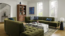 Marble-look coffee table surrounded by plush green seating