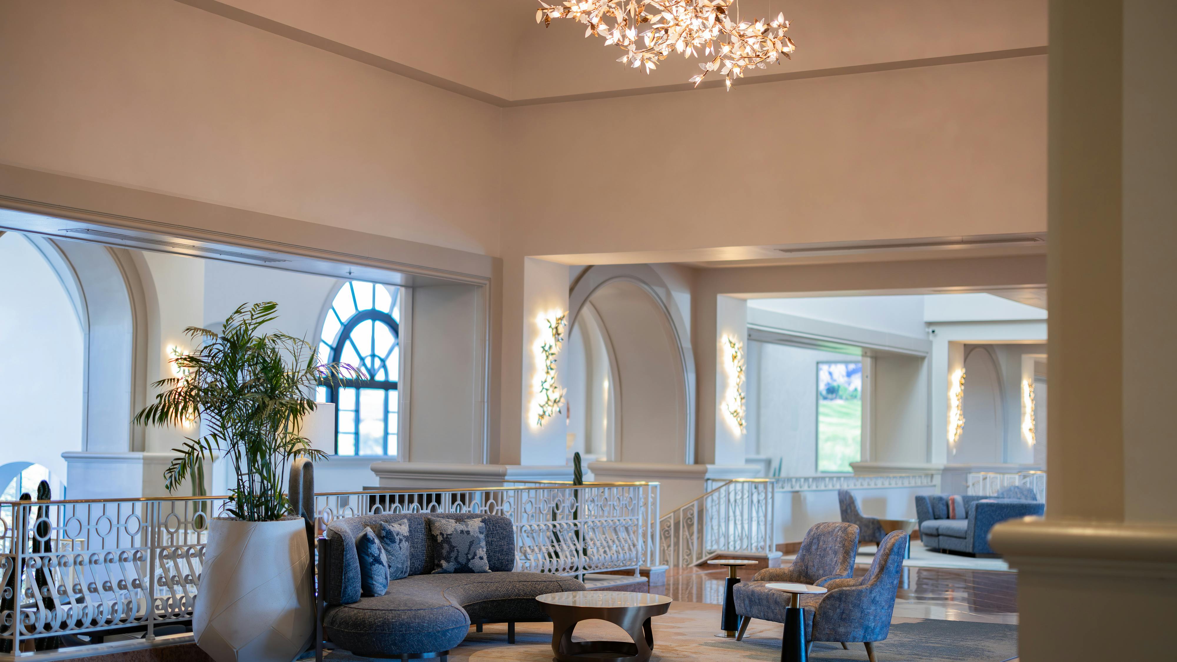 Lounge area with soft seating and chandelier overhead at the Westin La Paloma Hotel.