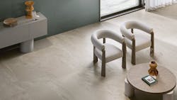 Fluida features Italian-made porcelain layers veining and minerals. It is shown installed in a communal space with chairs and tables. Fluida features Italian-made porcelain layers veining and minerals. It is shown installed in a communal space with chairs and tables.