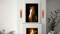 The Cape Wall Sconce has concealed LEDs to cast light upward and downward. The sconces are installed around a fireplace mantel. The Cape Wall Sconce has concealed LEDs to cast light upward and downward. The sconces are installed around a fireplace mantel.