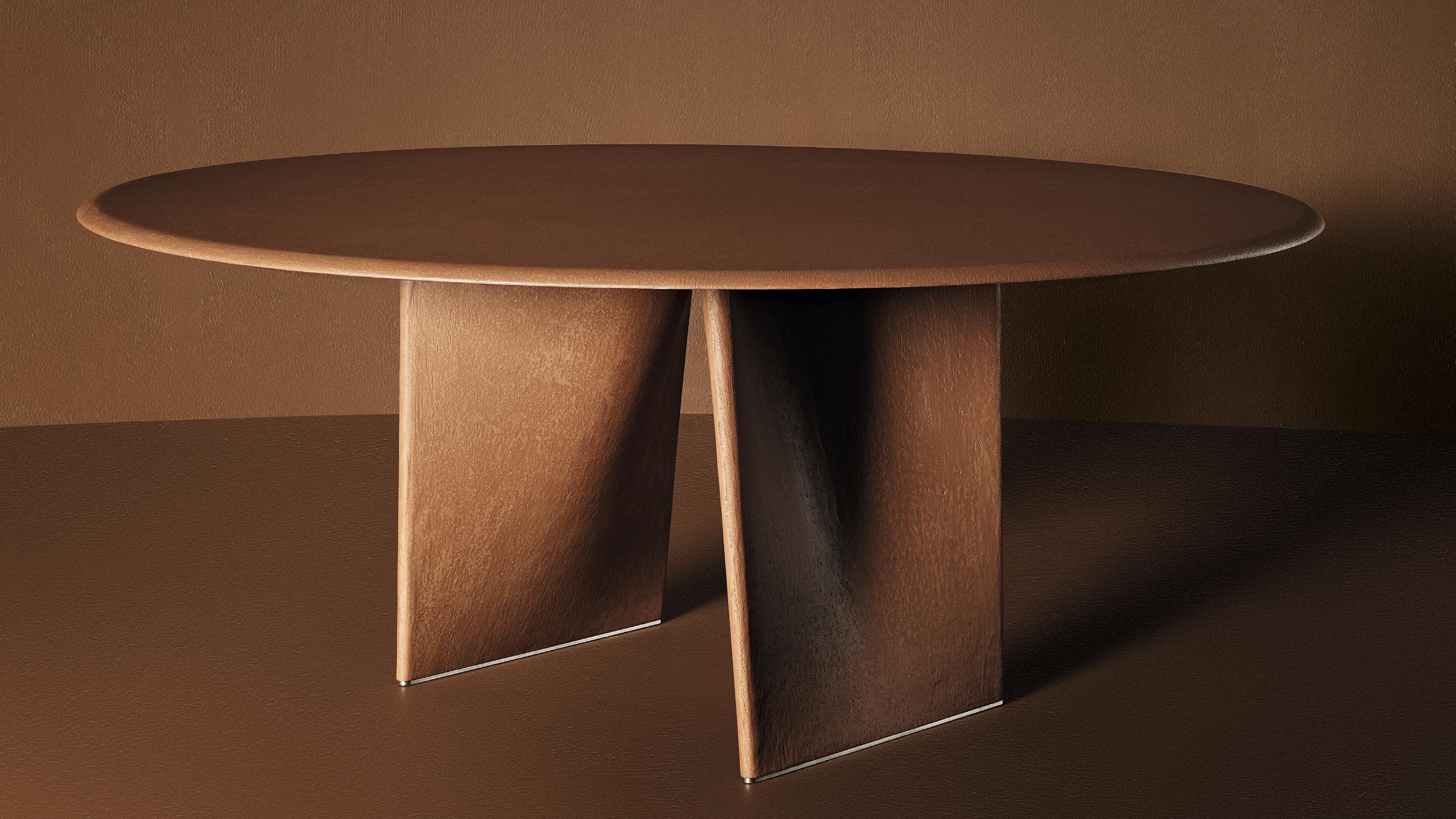 The Lambda Table has an origami-inspired base and two folded planes that converge.