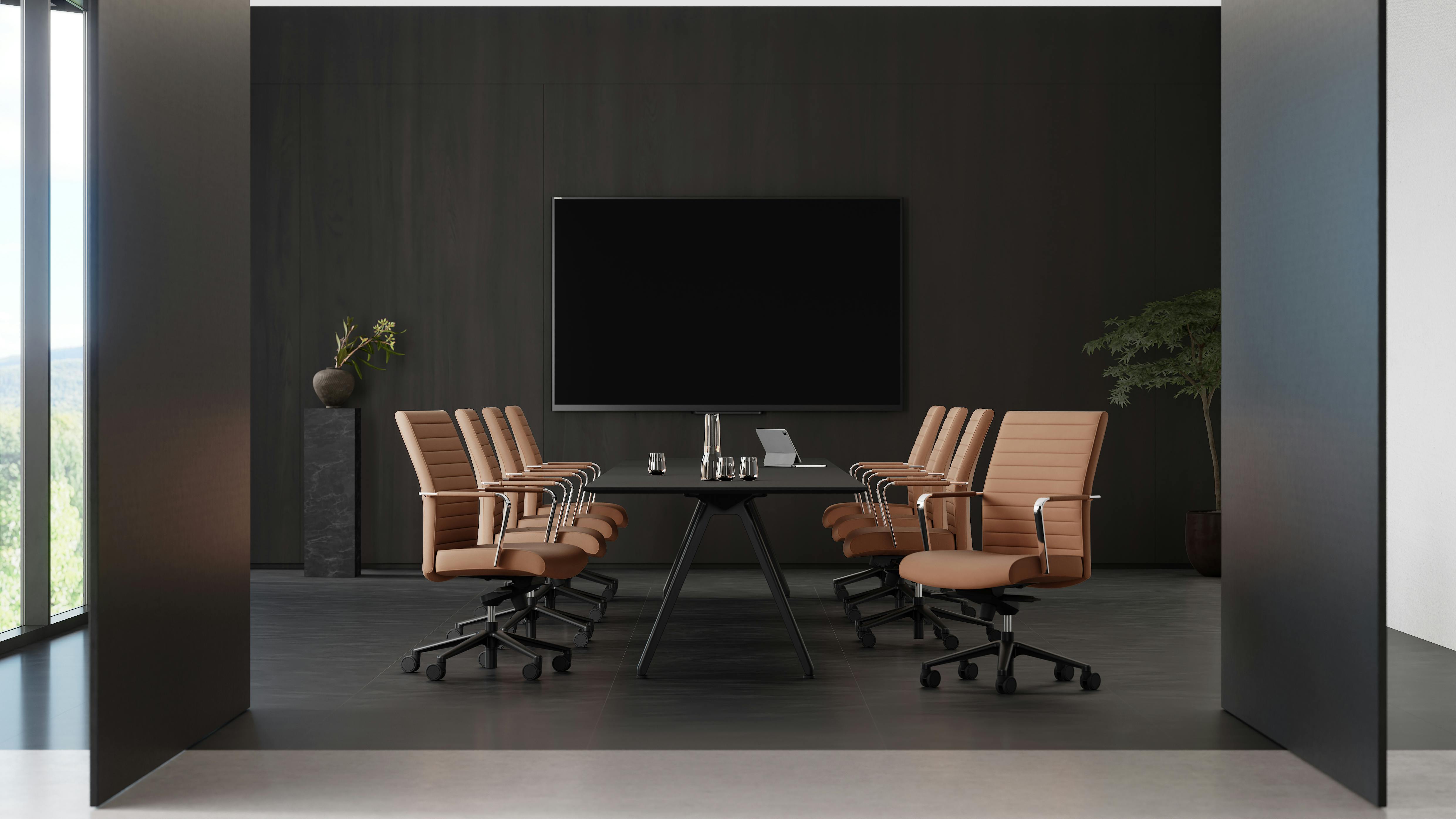 The Vanilla chair is available in low-, mid-, and high-back models. The chairs are shown in a meeting room setting.