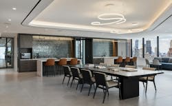 Work cafe and lounge space that features a curving ceiling light fixture, kitchenette countertops, and seating. Work cafe and lounge space that features a curving ceiling light fixture, kitchenette countertops, and seating.