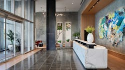 Visitors are immediately welcomed into the cool and understated reception area with its layered stone and wood finishes that provide shelter from the Texas heat, and are accented with a pop of color from locally sourced artwork. Visitors are immediately welcomed into the cool and understated reception area with its layered stone and wood finishes that provide shelter from the Texas heat, and are accented with a pop of color from locally sourced artwork.