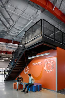 Texas ISD STEM students seated in a common area near the district-branded staircase in the STEM and Robotics Center Texas ISD STEM students seated in a common area near the district-branded staircase in the STEM and Robotics Center