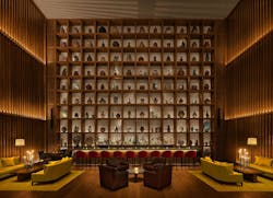 A honed marble bar and a Mayan glyph-inspired feature wall create dramatic focal points. A honed marble bar and a Mayan glyph-inspired feature wall create dramatic focal points.