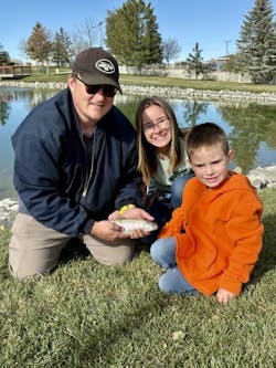 Dylan, Lauren, and Lukas Brant show off their fresh catch on a beautiful day at a pond Dylan, Lauren, and Lukas Brant show off their fresh catch on a beautiful day at a pond