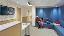 SCO Family of Services Genovese Family Life Center featuring blue upholstered seating area with patients waiting near long counter. SCO Family of Services Genovese Family Life Center featuring blue upholstered seating area with patients waiting near long counter.
