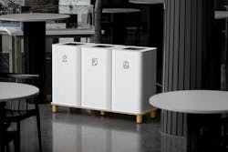 A trio of Arkad Recycling Bins shown in white and set on wooden stands. A trio of Arkad Recycling Bins shown in white and set on wooden stands.