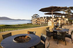 Expanded outdoor terrace at The Lodge at Pebble Beach overlooking the 18th green with fire pit tables and coastal views. Expanded outdoor terrace at The Lodge at Pebble Beach overlooking the 18th green with fire pit tables and coastal views.