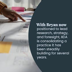 Designer hand pointing to printed/drawn plans Designer hand pointing to printed/drawn plans