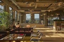 Open workspace with individual seating, soft brown lounge furnishings, abundant glazing for natural daylight, and coordinating globe and pendant lighting. Open workspace with individual seating, soft brown lounge furnishings, abundant glazing for natural daylight, and coordinating globe and pendant lighting.