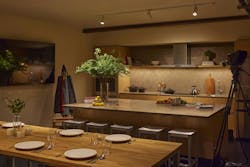 A media studio set up as a kitchen/dining area uses adjustable downlighting and soft cove/shelf lighting to create a warm, video-friendly ambience. A media studio set up as a kitchen/dining area uses adjustable downlighting and soft cove/shelf lighting to create a warm, video-friendly ambience.