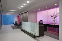 Commercial reception area with transparent glass panels in blue, lavender, and rose pink. Commercial reception area with transparent glass panels in blue, lavender, and rose pink.