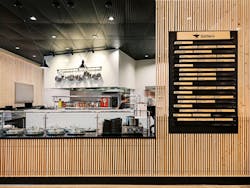 Food vendor counter with menu on wall featuring wood slatted front paneling. Food vendor counter with menu on wall featuring wood slatted front paneling.